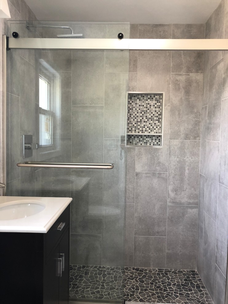 Design ideas for a small contemporary master bathroom in Newark with dark wood cabinets, a two-piece toilet, gray tile, porcelain tile, grey walls, porcelain floors, an undermount sink, marble benchtops, grey floor, white benchtops and flat-panel cabinets.