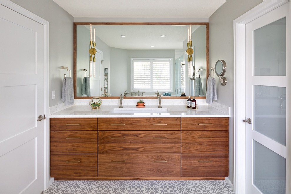 Design ideas for a mid-sized contemporary master bathroom in Denver with flat-panel cabinets, brown cabinets, a freestanding tub, a corner shower, gray tile, ceramic tile, grey walls, cement tiles, a drop-in sink, quartzite benchtops, white floor, a hinged shower door and white benchtops.