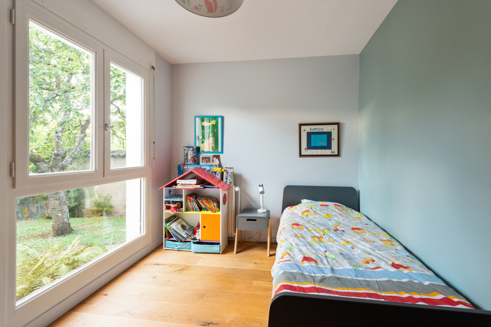 Inspiration for a mid-sized contemporary kids' bedroom for kids 4-10 years old and boys in Lyon with green walls, travertine floors and beige floor.