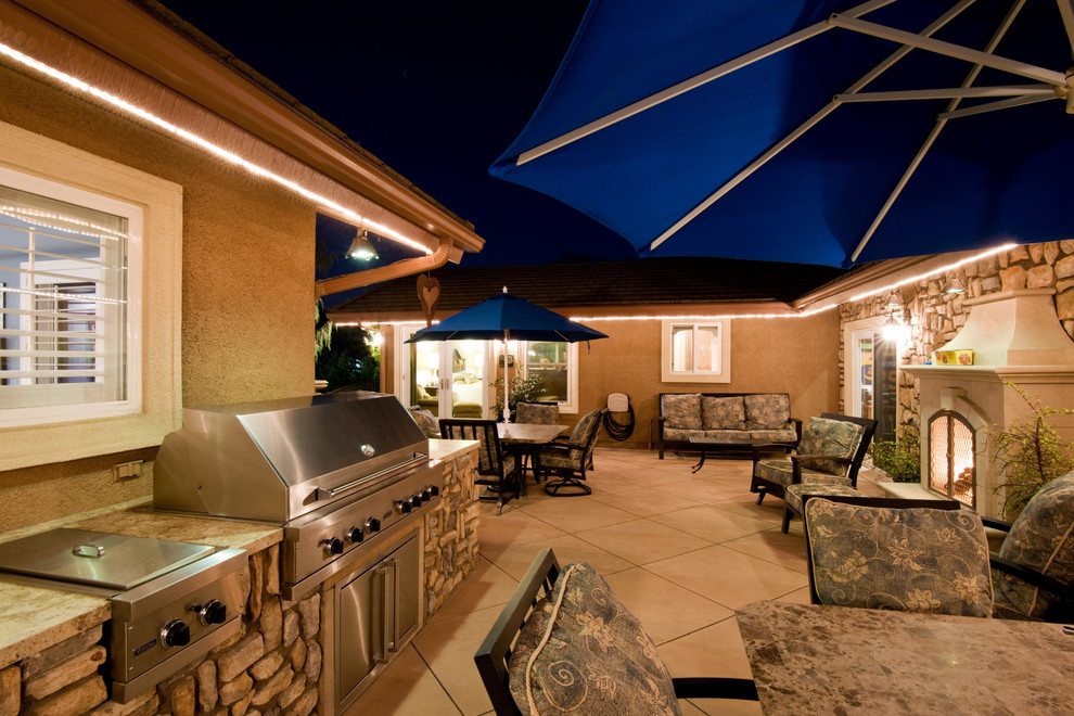 Photo of a large modern backyard patio in Los Angeles with an outdoor kitchen, concrete slab and no cover.