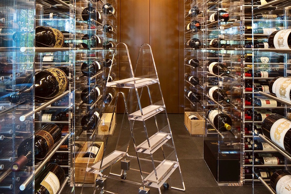 Photo of an expansive modern wine cellar in San Francisco with slate floors, storage racks and brown floor.