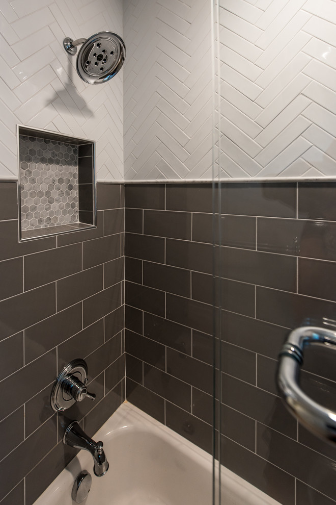 Mid-sized transitional 3/4 bathroom in DC Metro with shaker cabinets, medium wood cabinets, a drop-in tub, a two-piece toilet, white tile, porcelain tile, grey walls, porcelain floors, a pedestal sink, brown floor and a sliding shower screen.