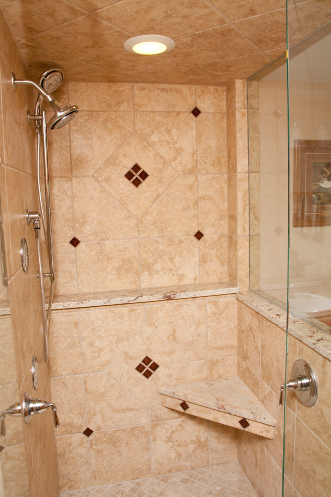 Mid-sized traditional master bathroom in Milwaukee with raised-panel cabinets, medium wood cabinets, an alcove shower, a two-piece toilet, beige tile, porcelain tile, multi-coloured walls, porcelain floors, a drop-in sink and granite benchtops.