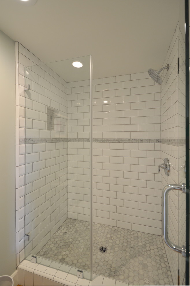 Design ideas for a mid-sized country 3/4 bathroom in Los Angeles with an alcove shower, white tile, grey walls, shaker cabinets, white cabinets, a one-piece toilet, ceramic tile, medium hardwood floors, an undermount sink and marble benchtops.