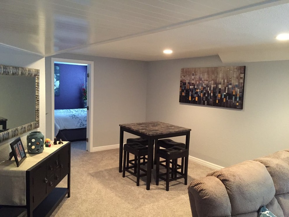 Inspiration for a mid-sized transitional underground carpeted and beige floor basement remodel in Denver with gray walls and no fireplace
