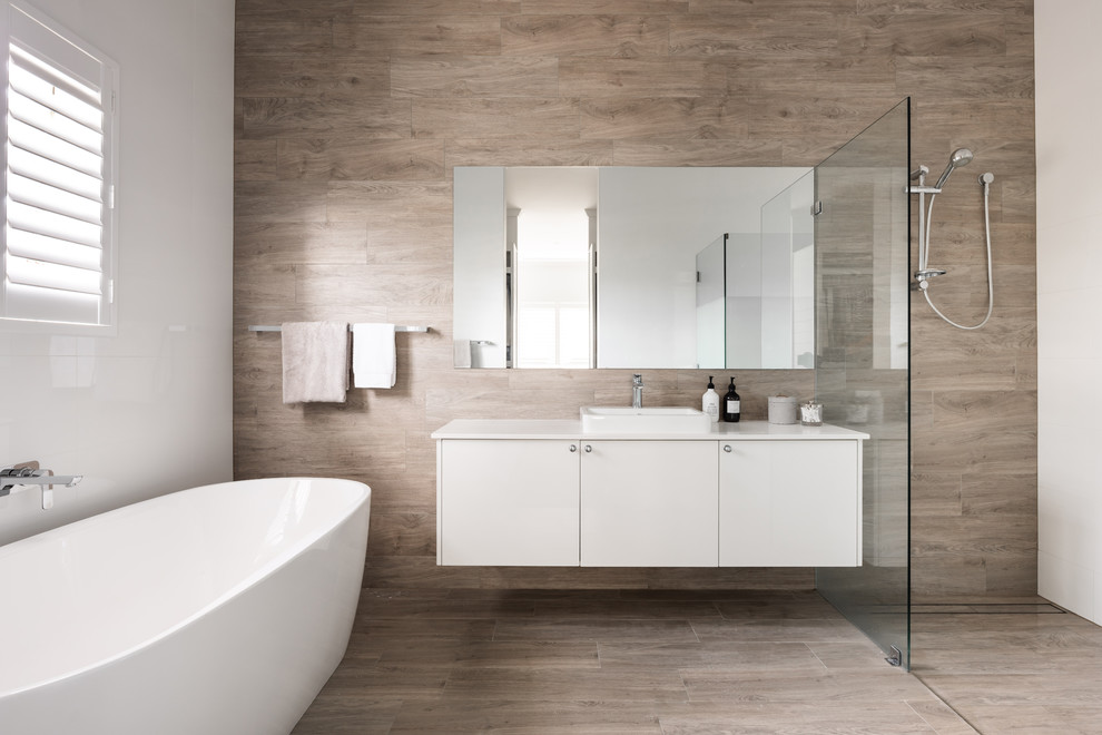 Contemporary master bathroom in Perth with flat-panel cabinets, white cabinets, a freestanding tub, a curbless shower, gray tile, a vessel sink, grey floor and white benchtops.
