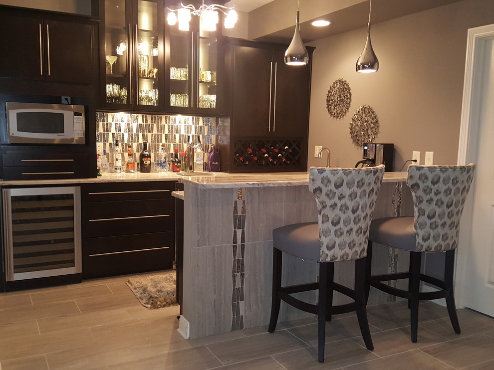 This is an example of a mid-sized modern u-shaped wet bar in Indianapolis with an undermount sink, flat-panel cabinets, black cabinets, limestone benchtops, grey splashback, glass tile splashback and ceramic floors.