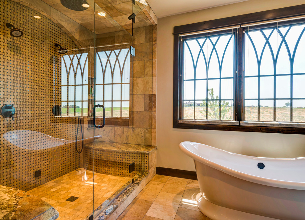 Design ideas for a large arts and crafts master bathroom in Denver with a freestanding tub, an alcove shower, beige tile, porcelain tile, beige walls, ceramic floors, brown floor and a hinged shower door.