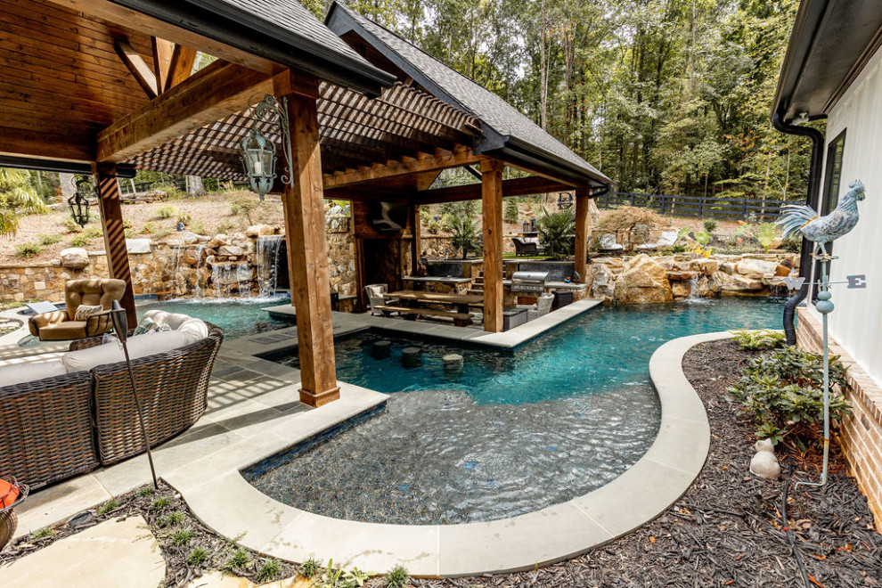 Design ideas for a large traditional backyard pool in Atlanta with a pool house.
