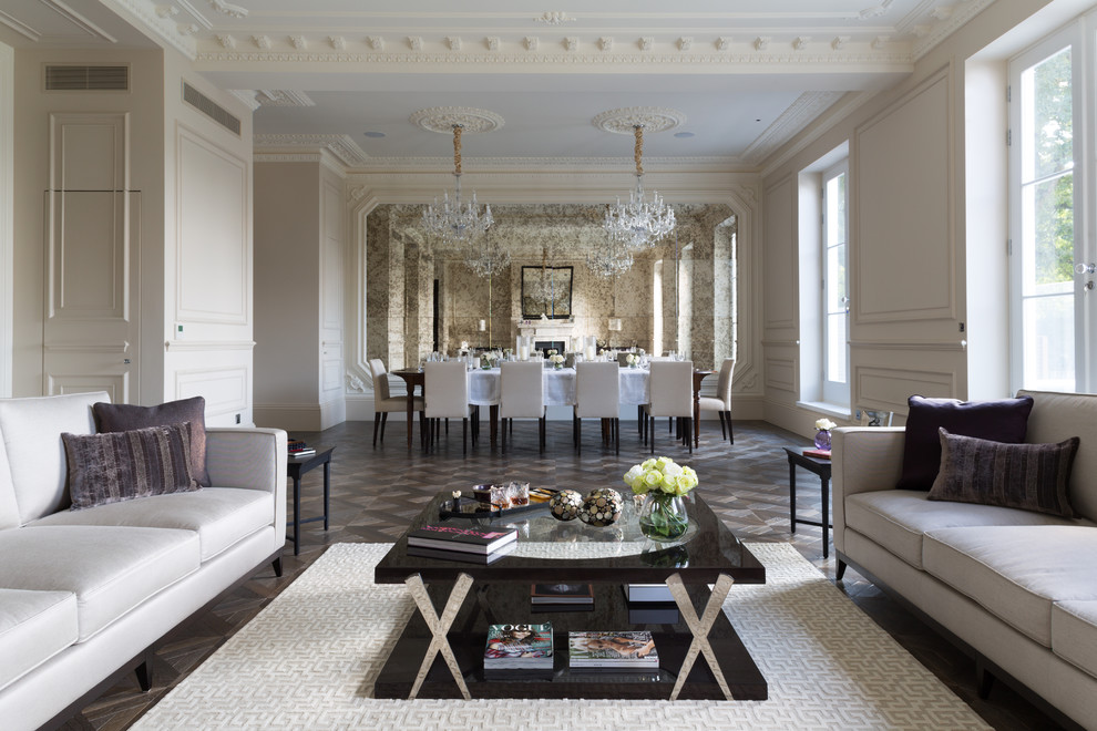 Traditional formal open concept living room in London with white walls and grey floor.