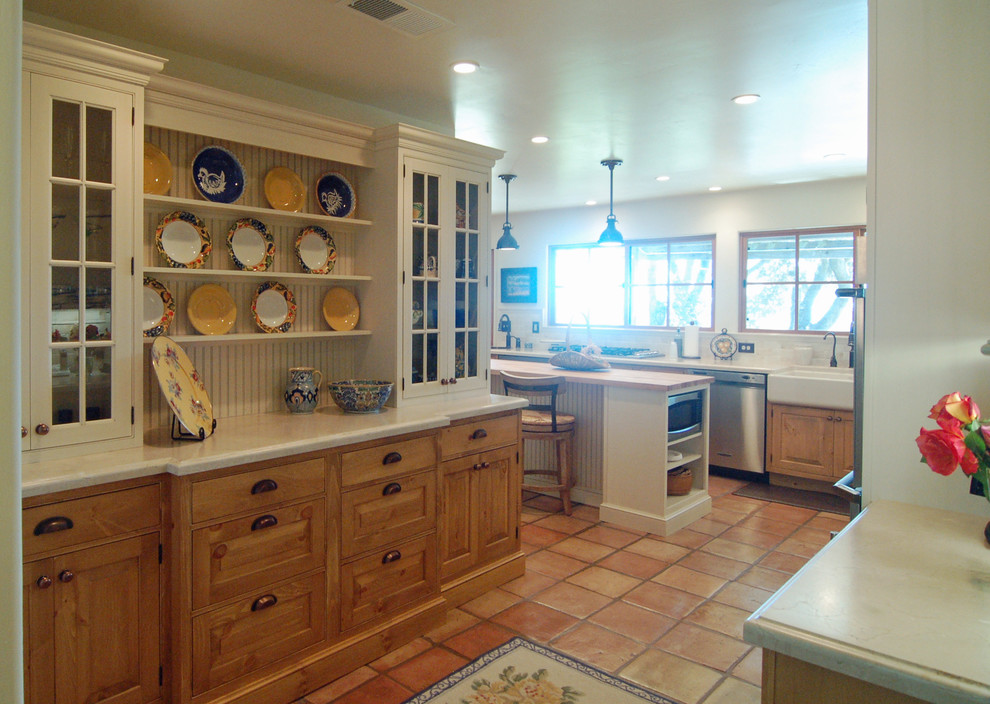 Inspiration for a large country l-shaped separate kitchen in San Luis Obispo with a farmhouse sink, beaded inset cabinets, white cabinets, limestone benchtops, white splashback, stone tile splashback, stainless steel appliances, terra-cotta floors and with island.