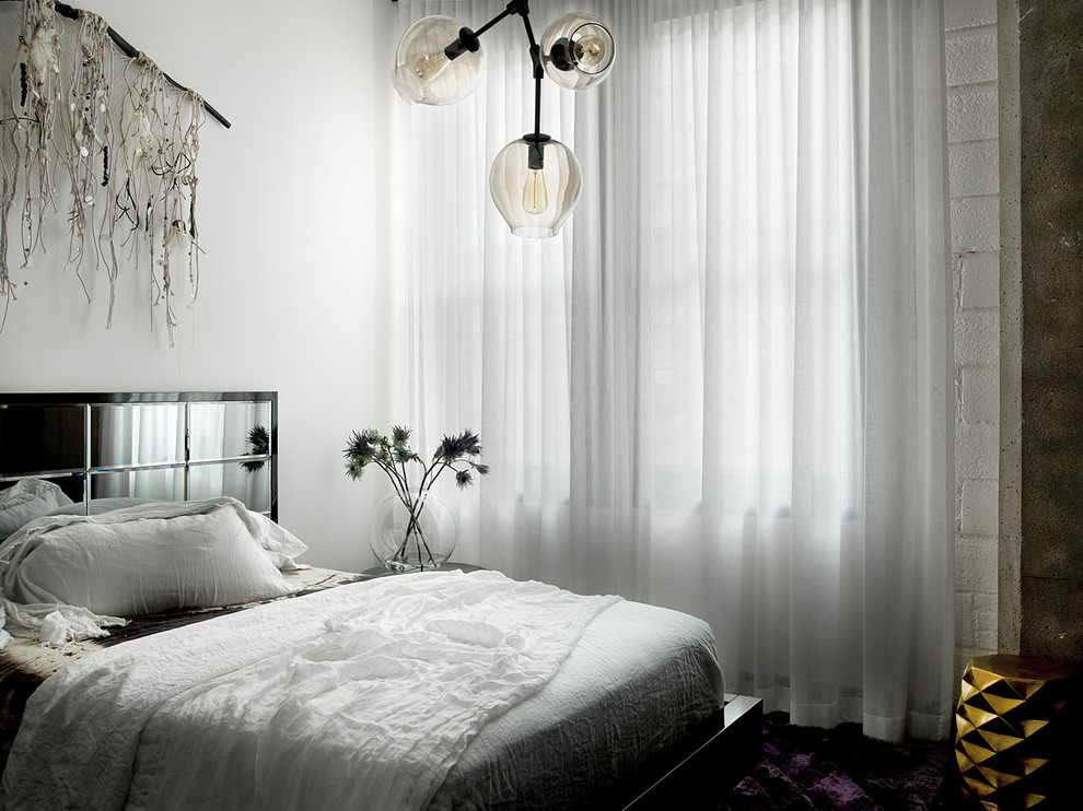 Photo of a contemporary master bedroom in Chicago with white walls.