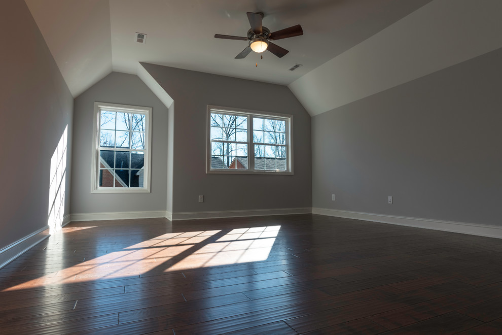 Example of a mid-sized transitional master dark wood floor bedroom design with gray walls and no fireplace