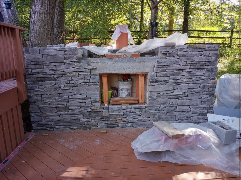 STONE FIREPLACE  , BBQ GRILL   AND STONE RETAINING WALL