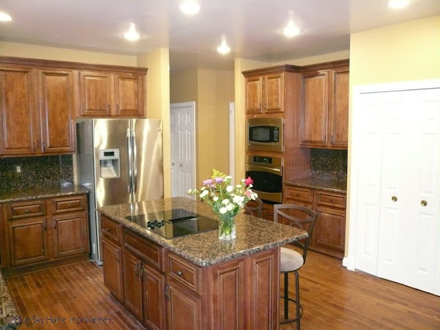 Transitional kitchen photo in DC Metro with beaded inset cabinets, medium tone wood cabinets and an island