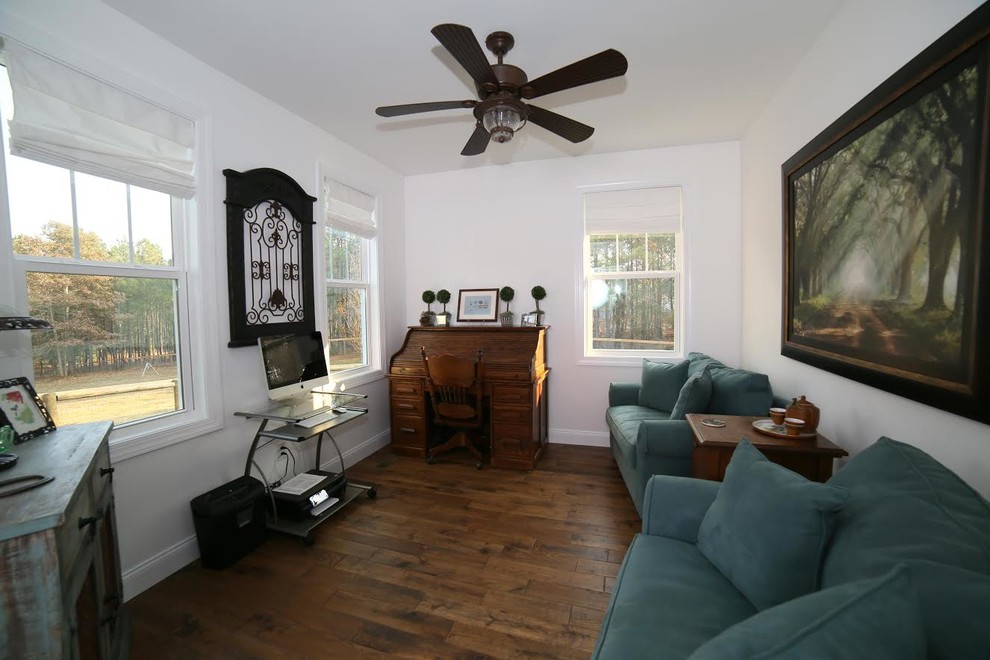 Mid-sized traditional study room in Atlanta with white walls, medium hardwood floors and a freestanding desk.
