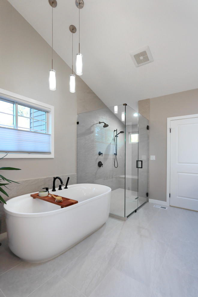 Example of a large transitional master beige tile and porcelain tile porcelain tile, beige floor, double-sink and vaulted ceiling freestanding bathtub design in Seattle with shaker cabinets, gray cabinets, beige walls, an undermount sink, quartz countertops, a hinged shower door, white countertops and a built-in vanity