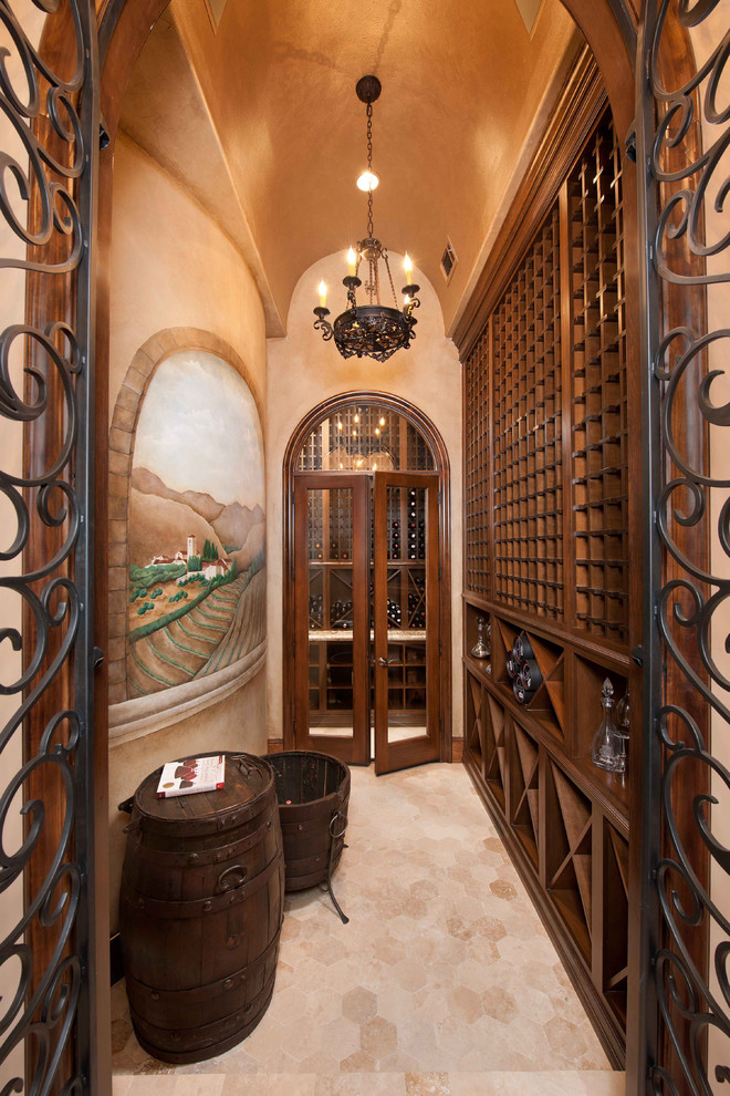 This is an example of a mid-sized traditional wine cellar with travertine floors, diamond bins and beige floor.