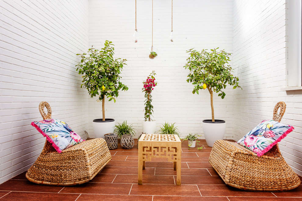 Mid-sized mediterranean side yard patio in Madrid with a container garden.