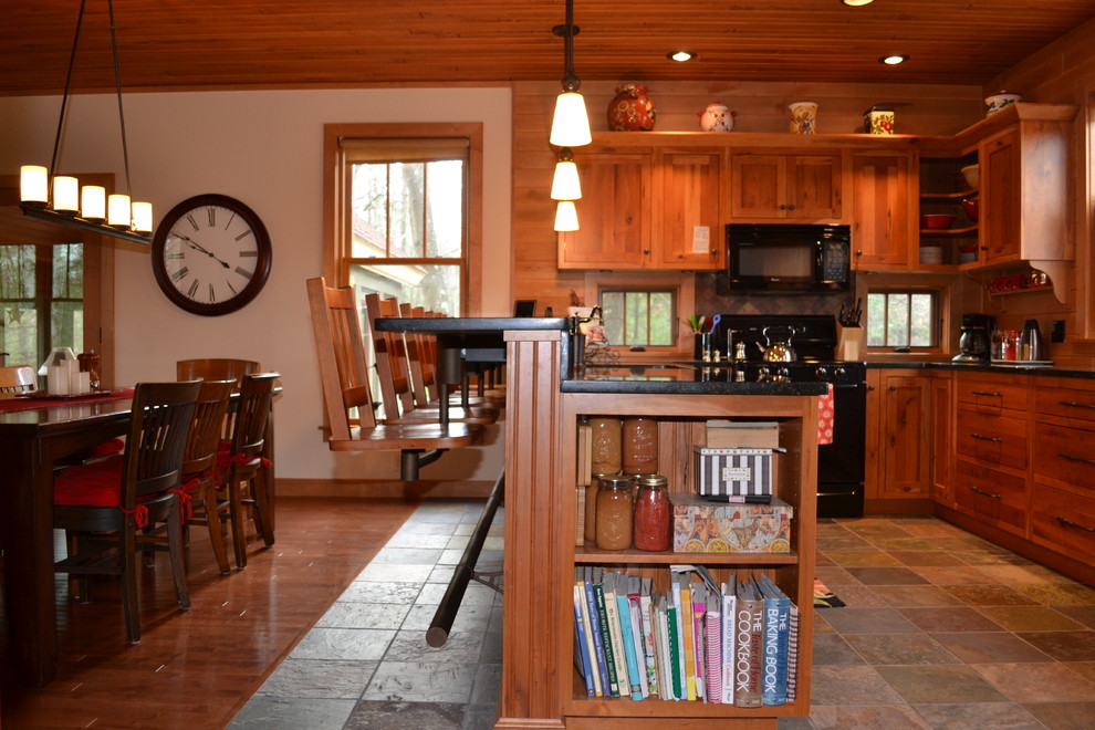 Enclosed kitchen - mid-sized rustic l-shaped dark wood floor enclosed kitchen idea with medium tone wood cabinets, black appliances and no island