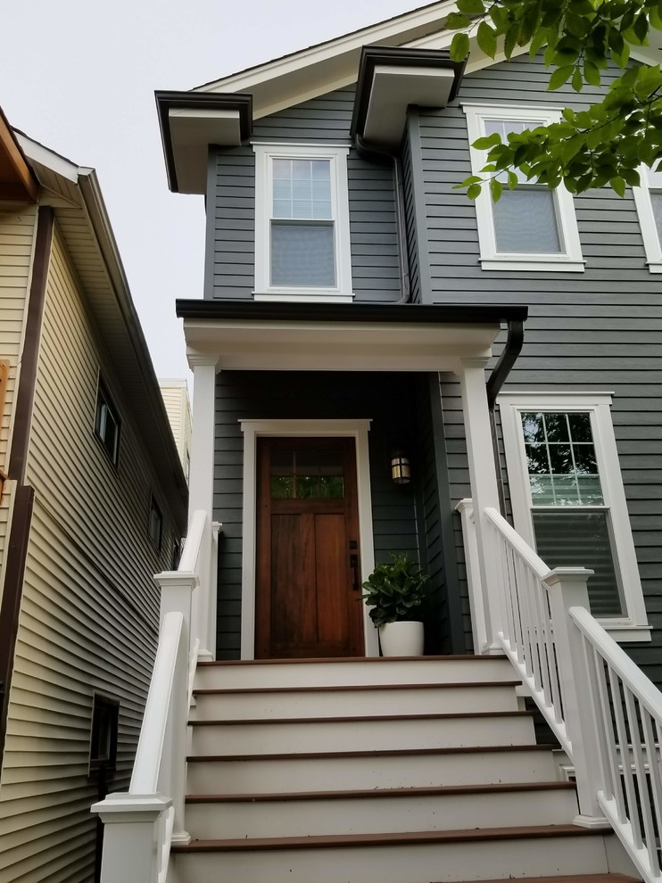 This is an example of a mid-sized traditional front door in Chicago with grey walls, a single front door, wood, a brown front door, brown floor, panelled walls and painted wood floors.