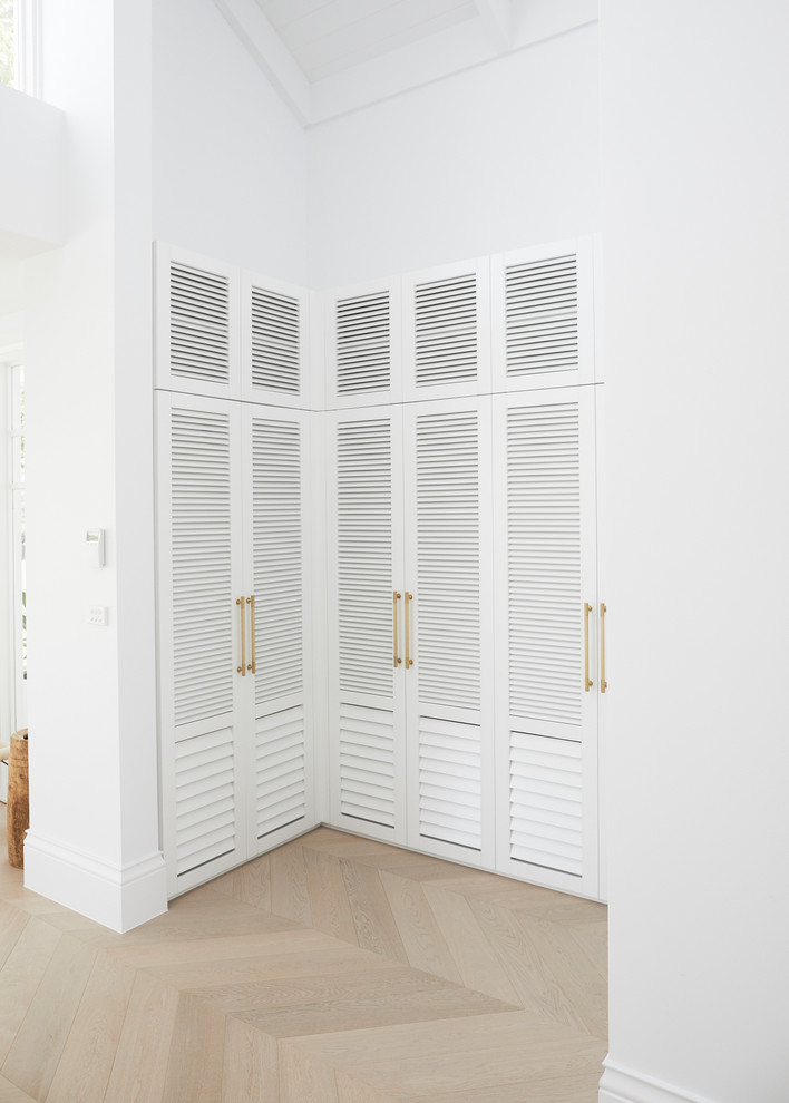 This is an example of a mid-sized beach style mudroom in Sydney with white walls.