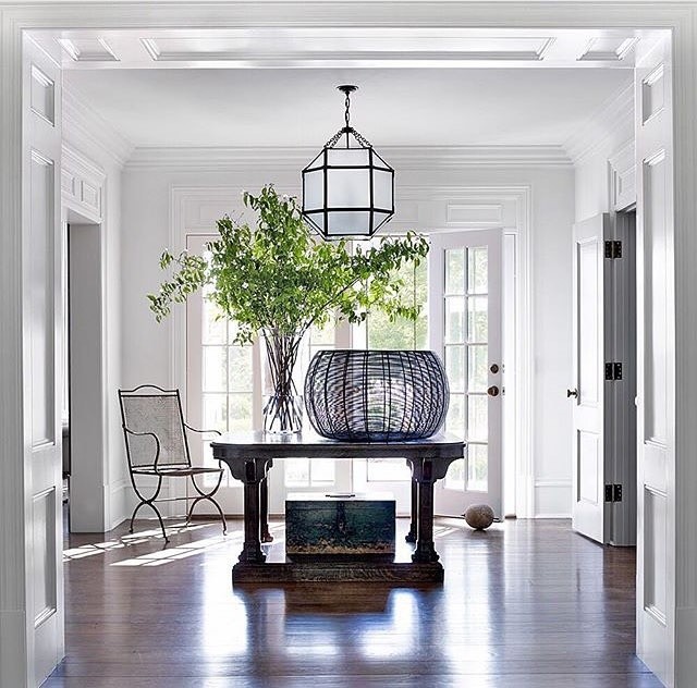 Photo of a large transitional foyer in Other with white walls, dark hardwood floors, a double front door and a glass front door.