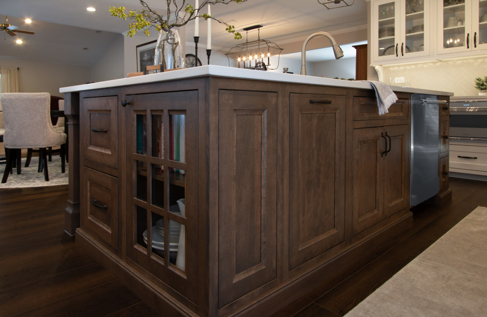 Example of a transitional kitchen design in Chicago with white cabinets, quartz countertops, ceramic backsplash, stainless steel appliances, an island and white countertops