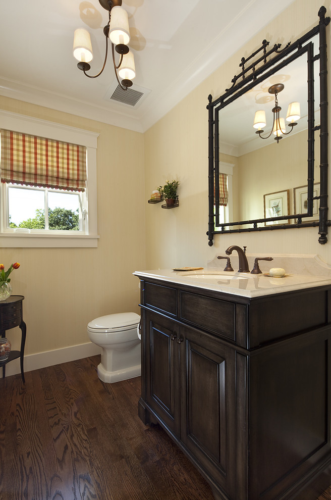 Photo of a traditional bathroom in San Francisco with dark wood cabinets.