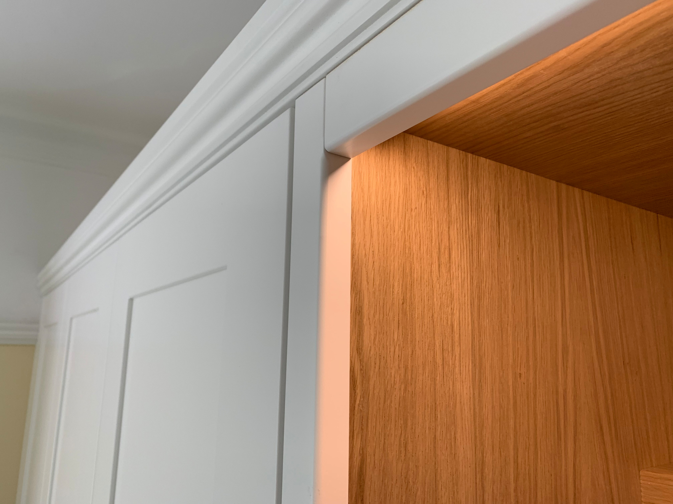 Wardrobes with white spray painted shaker doors and oak desk area