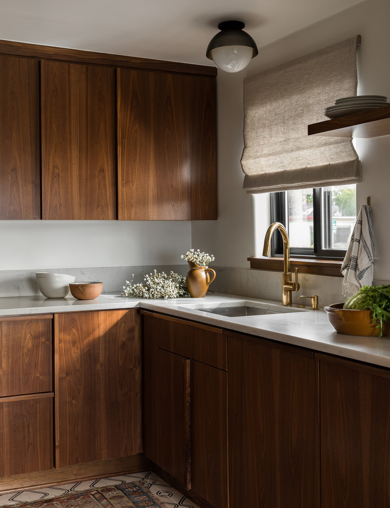 Photo of a midcentury l-shaped kitchen in Seattle with an undermount sink, flat-panel cabinets, medium wood cabinets, grey splashback, multi-coloured floor and grey benchtop.