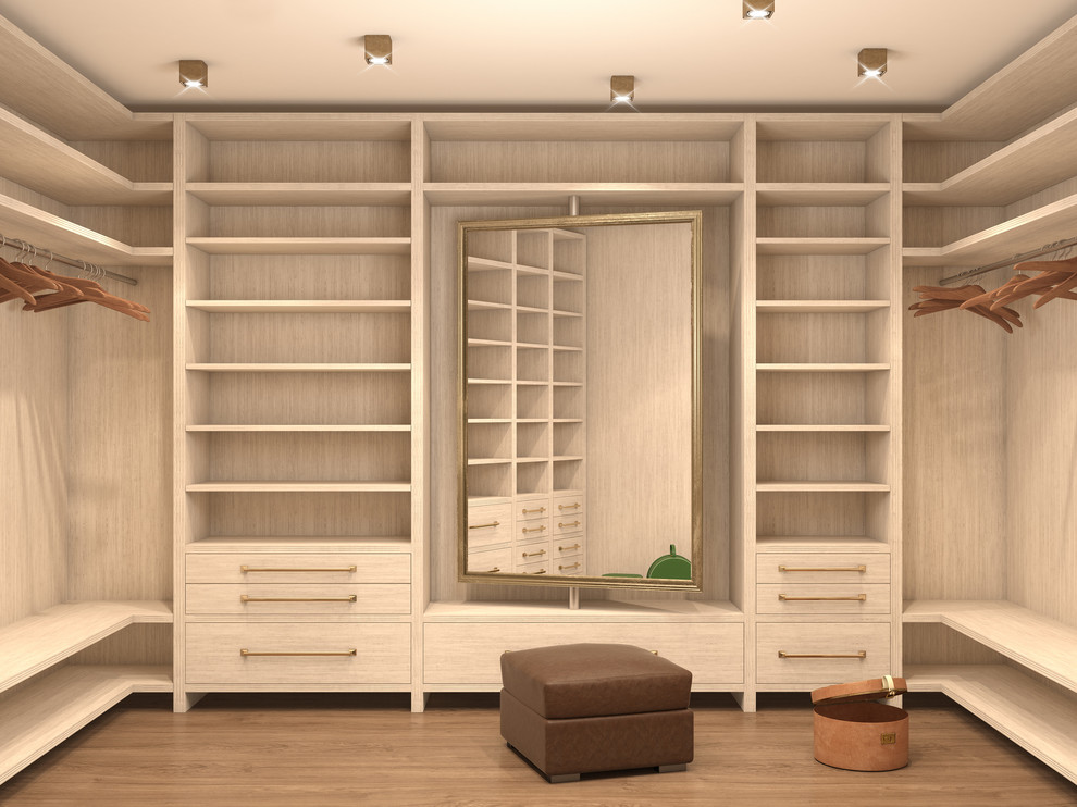 This is an example of a small gender-neutral walk-in wardrobe in New York with light hardwood floors and brown floor.
