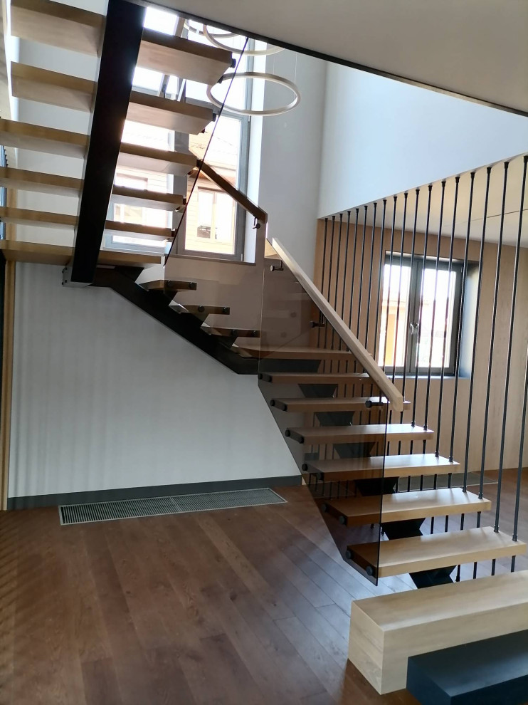 Example of a large trendy wooden l-shaped wood railing staircase design in Saint Petersburg