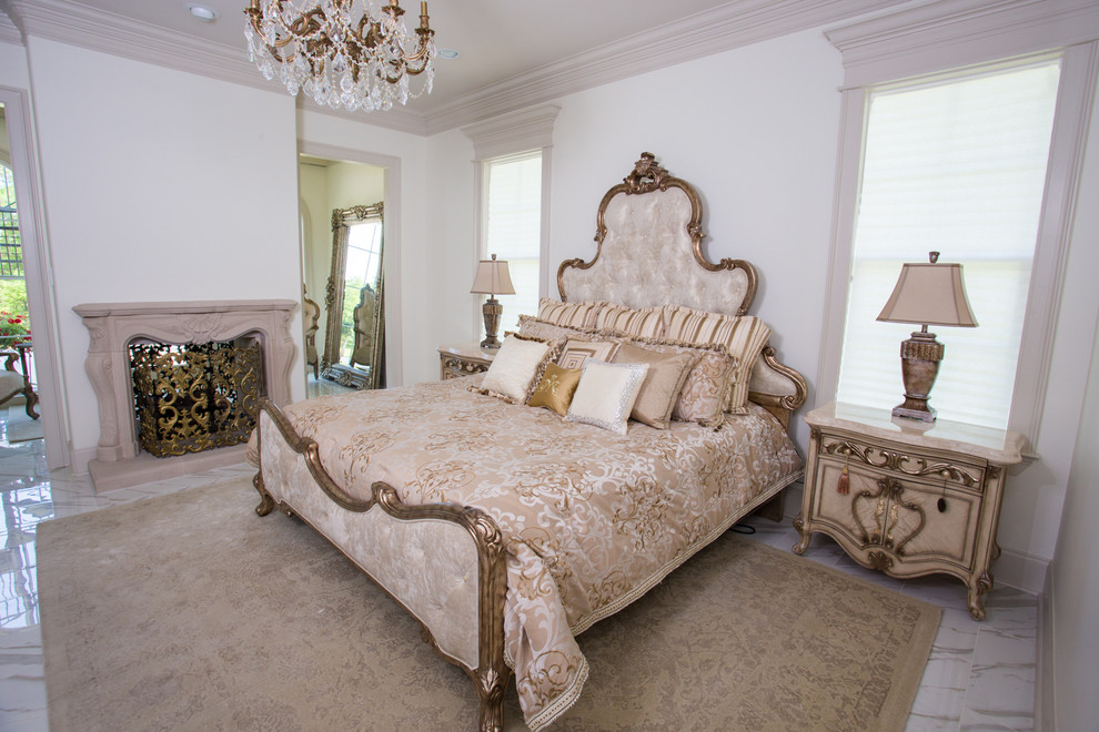 Inspiration for an expansive traditional master bedroom in New Orleans with white walls, ceramic floors, a two-sided fireplace and a plaster fireplace surround.