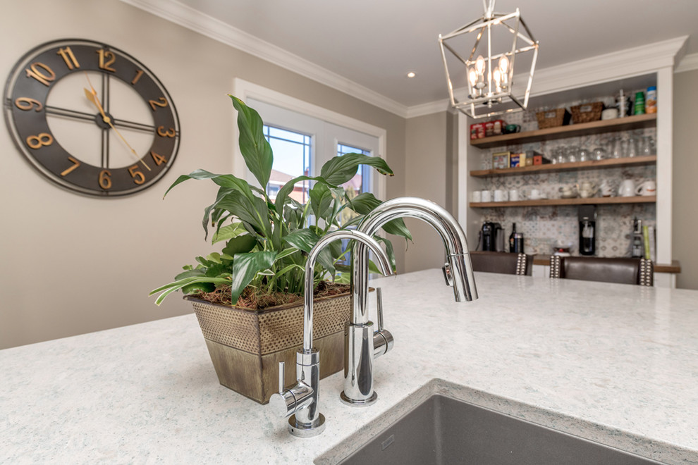 Example of a large transitional galley dark wood floor and brown floor eat-in kitchen design with an undermount sink, shaker cabinets, white cabinets, quartz countertops, multicolored backsplash, mosaic tile backsplash, stainless steel appliances, an island and multicolored countertops