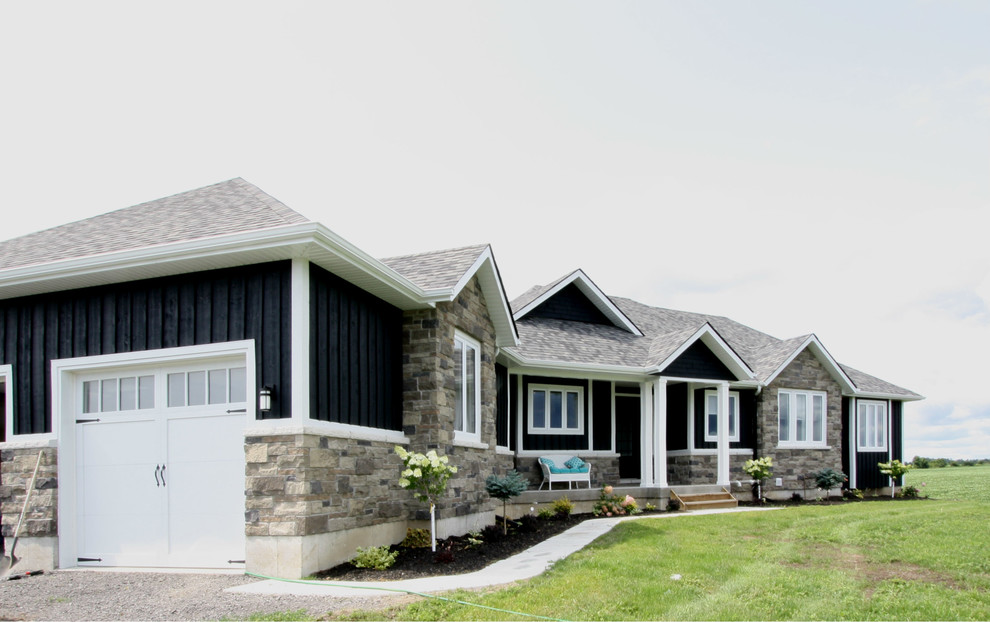 Example of a mid-sized transitional black one-story wood gable roof design in Toronto with a shingle roof