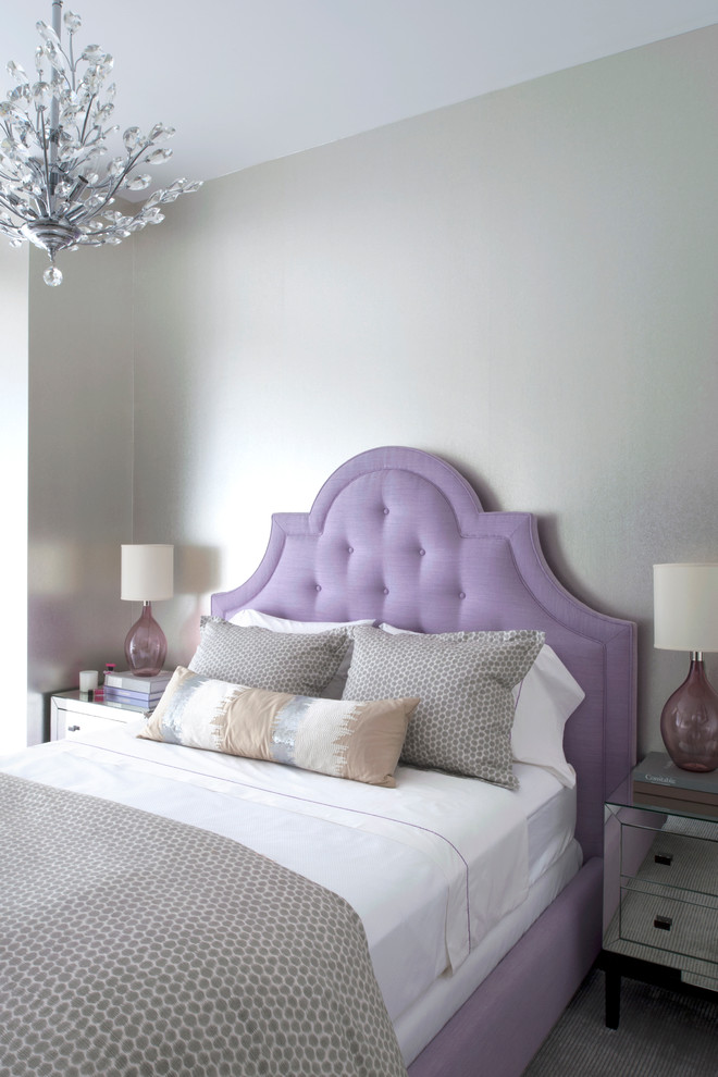 Photo of a transitional bedroom in New York with grey walls.