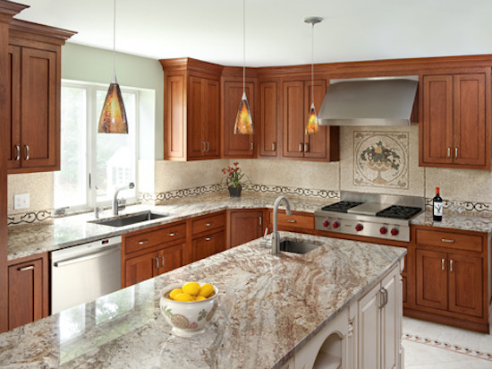 Kitchen photo in Boston with recessed-panel cabinets, medium tone wood cabinets, beige backsplash and stainless steel appliances