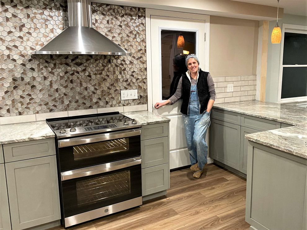 Example of a large transitional u-shaped vinyl floor and brown floor eat-in kitchen design in Boston with an undermount sink, recessed-panel cabinets, gray cabinets, marble countertops, beige backsplash, porcelain backsplash, stainless steel appliances, a peninsula and multicolored countertops