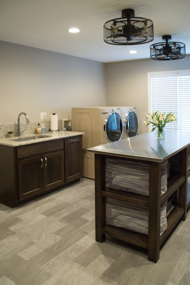 Transitional gray floor utility room photo with an utility sink, recessed-panel cabinets, granite countertops, gray walls and a side-by-side washer/dryer