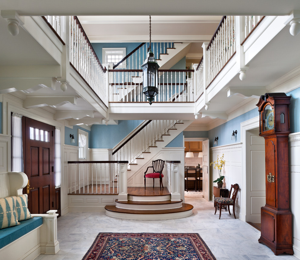 This is an example of a traditional foyer in Philadelphia with blue walls, a single front door and a dark wood front door.