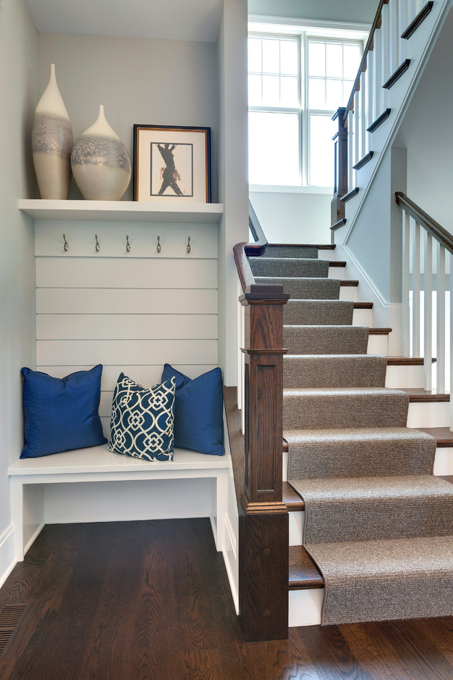 Traditional wood u-shaped staircase in Minneapolis with painted wood risers.