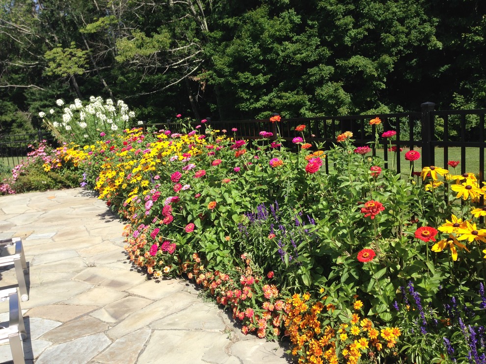 Mid-sized country backyard garden in Boston with natural stone pavers.