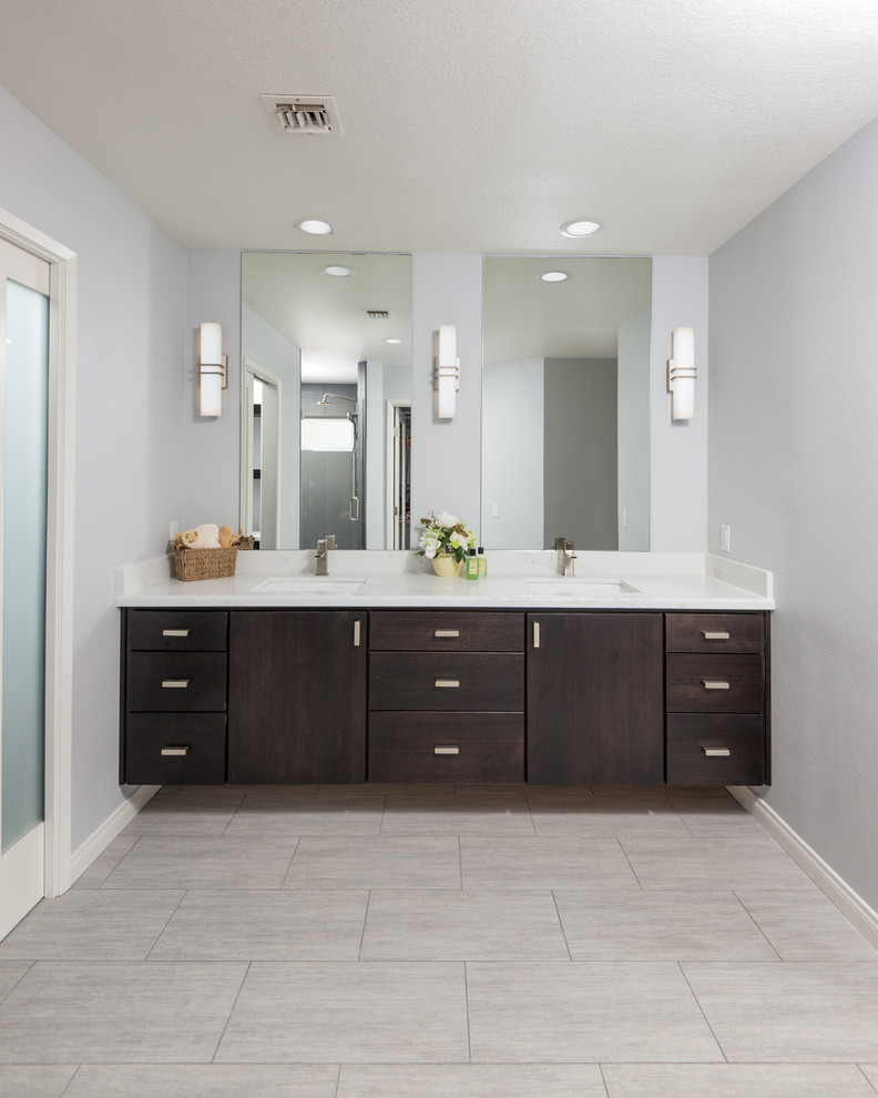 Photo of a large transitional master bathroom in San Diego with flat-panel cabinets, dark wood cabinets, an alcove shower, a one-piece toilet, gray tile, ceramic tile, grey walls, ceramic floors, an undermount sink and granite benchtops.
