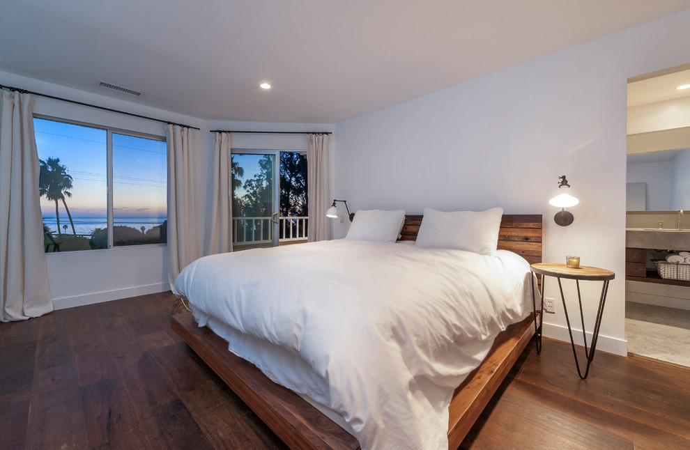 Design ideas for a beach style master bedroom in San Diego with medium hardwood floors.