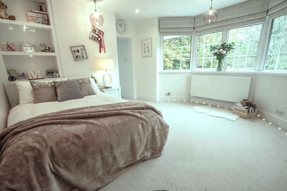 Inspiration for a contemporary bedroom in Surrey with white walls and carpet.