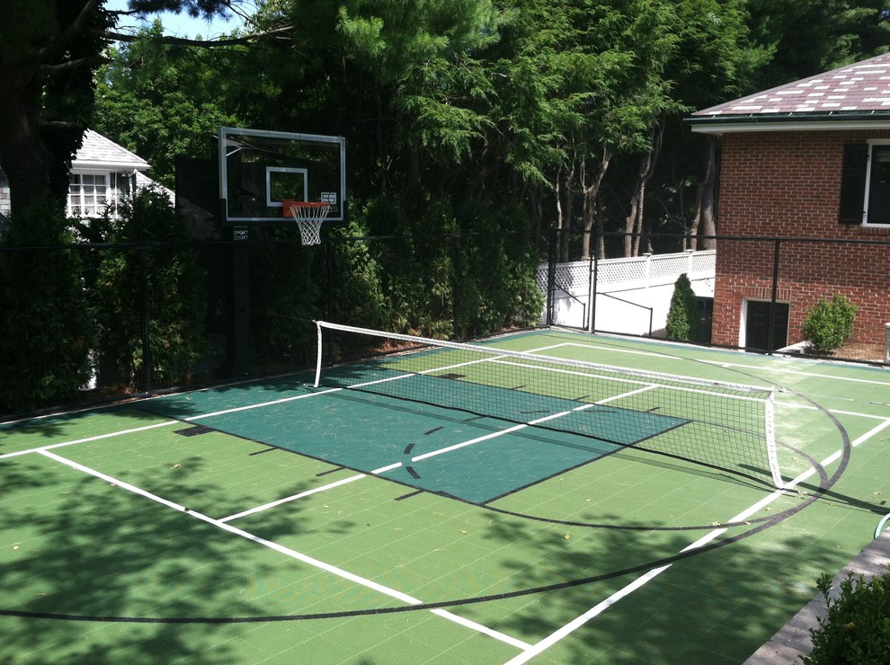 This is an example of a small traditional backyard partial sun outdoor sport court in Boston with with outdoor playset and natural stone pavers.