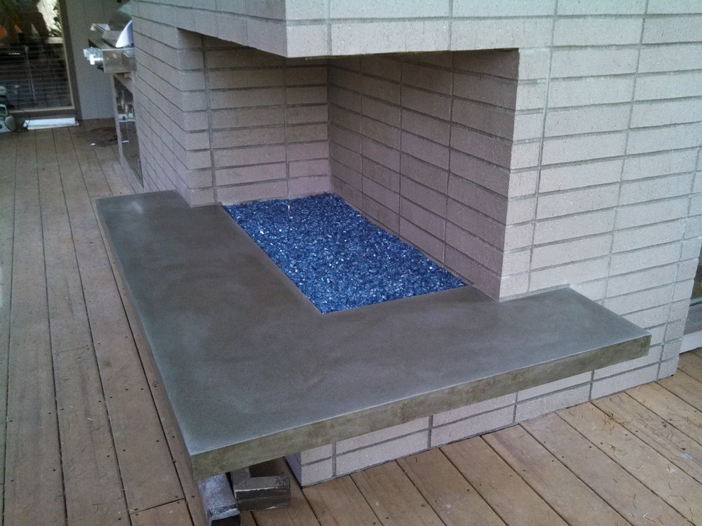 This is an example of a mid-sized midcentury backyard deck in Portland with a fire feature.