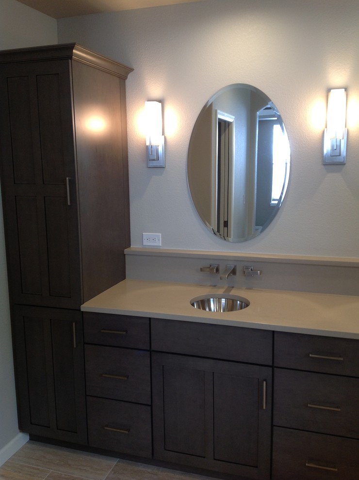 Mid-sized transitional 3/4 porcelain tile and double-sink corner shower photo in Denver with shaker cabinets, dark wood cabinets, beige walls, an undermount sink, solid surface countertops and a built-in vanity