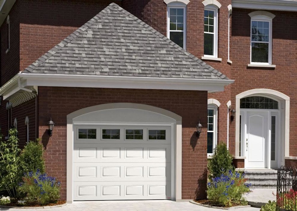 This is an example of a mid-sized traditional attached one-car garage in Cedar Rapids.